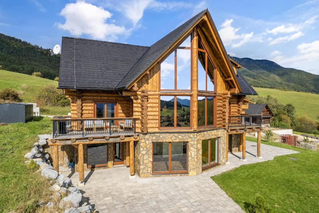 a log home with a gambrel roof at Chalet Liptov Izipovce in Ižipovce