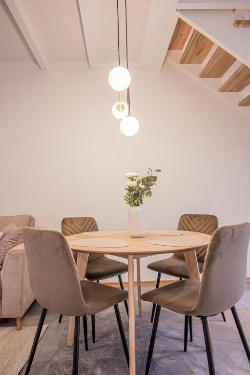 a dining room with a wooden table and chairs at Lai Residence Apartment 1 in Tartu