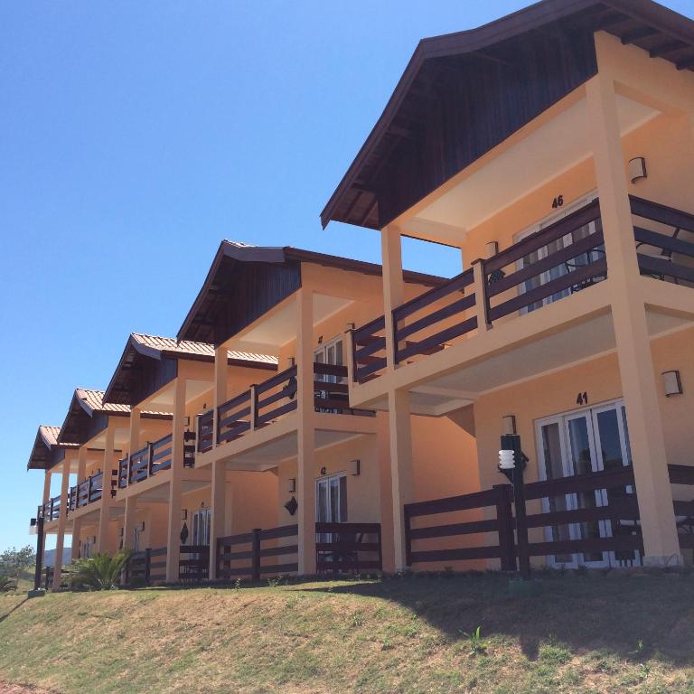 a building with balconies on the side of it at Hotel Fazenda Santa Maria in Serra Negra