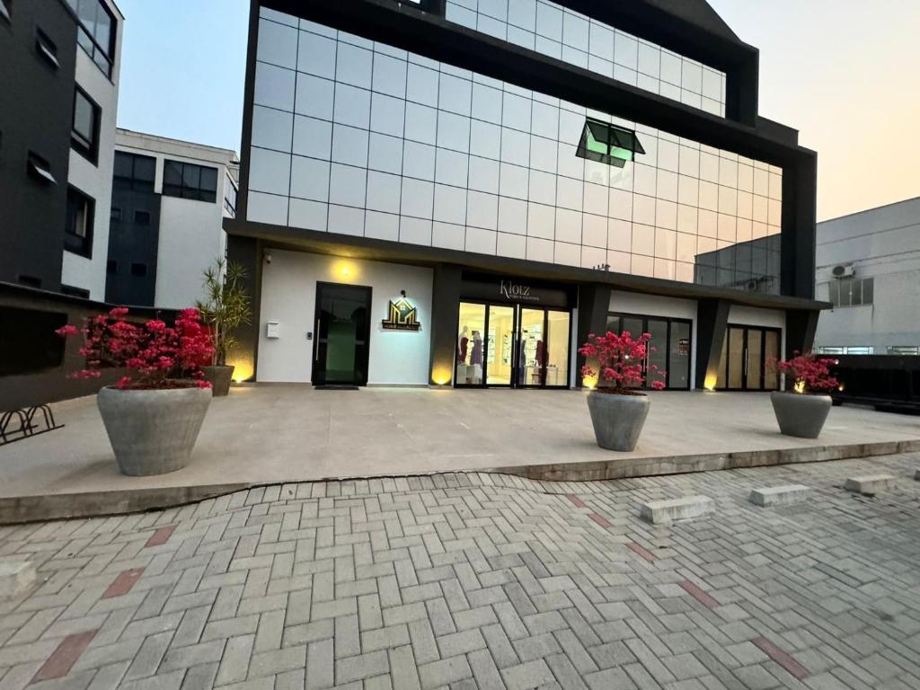 a large building with potted plants in front of it at Flat Home Business 401 Centro de Pomerode in Pomerode