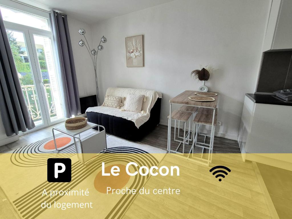 a living room with a couch and a table at Le Cocon-T2-Proche du centre-Wifi in Lourdes