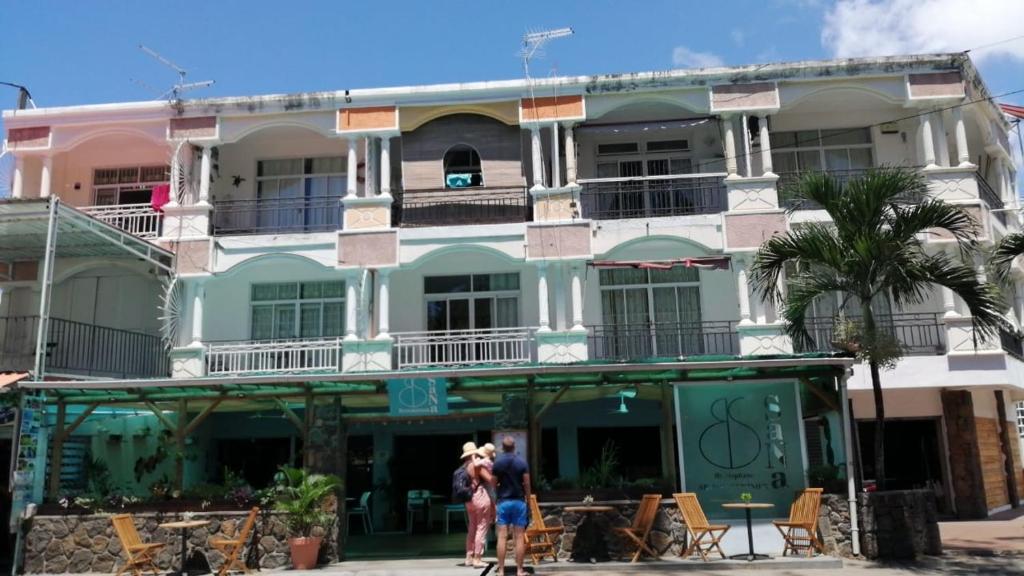 a group of people standing in front of a building at Tropical Holidays MU in Pereybere