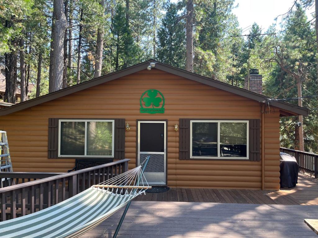 a log cabin with a hammock in front of it at Mountain Life On Deck in Arnold