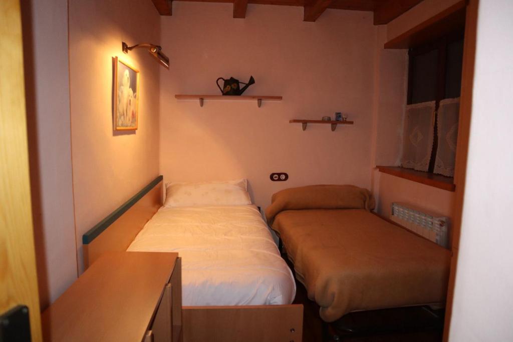 Postel nebo postele na pokoji v ubytování ERA CASETA de Salardu