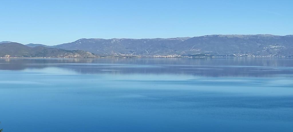 a large body of water with mountains in the background at ROYAL VIEW Apartments in Struga