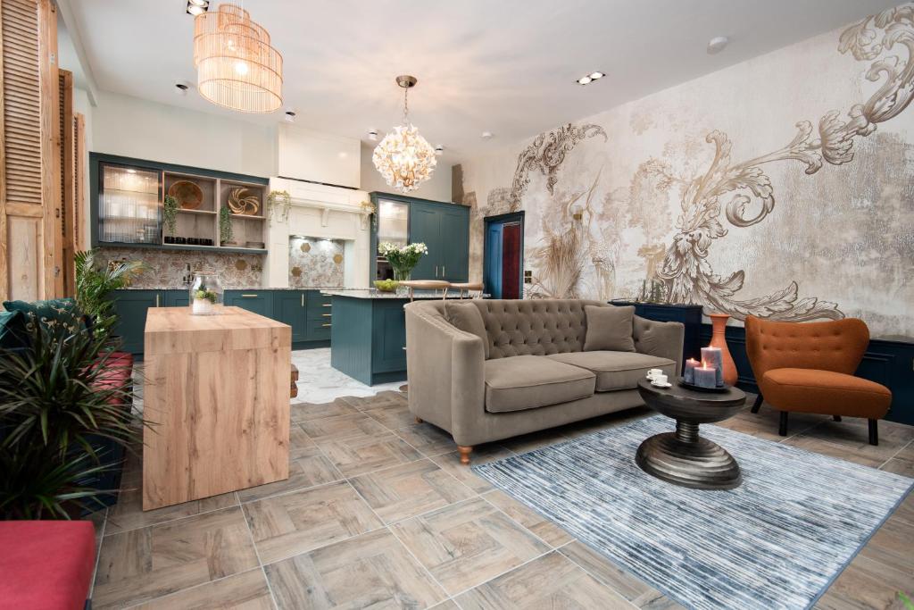 a living room with a couch and a table at The Balcony Luxury Apartment in Berwick-Upon-Tweed