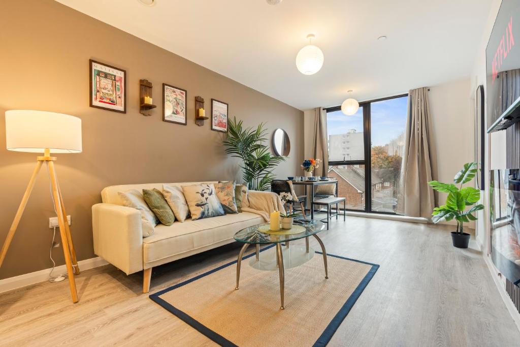 a living room with a couch and a table at City Centre Birmingham 1-Bed with WiFi and Parking in Birmingham