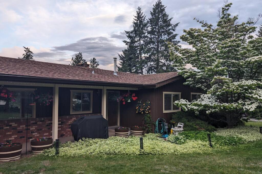 a small house with a yard with a yard at Spacious West Kelowna Home that is great for family, friends, or business trip! in West Kelowna