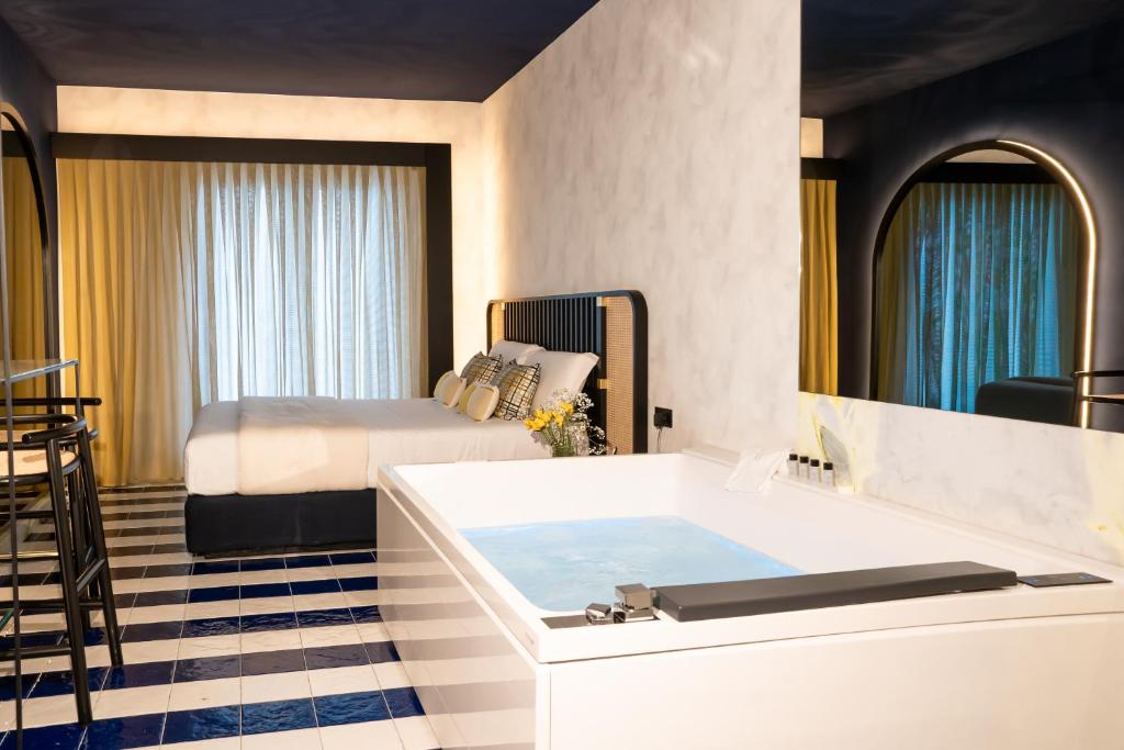 a hotel room with a tub and a bed at Hotel Orizzonte in Giugliano in Campania