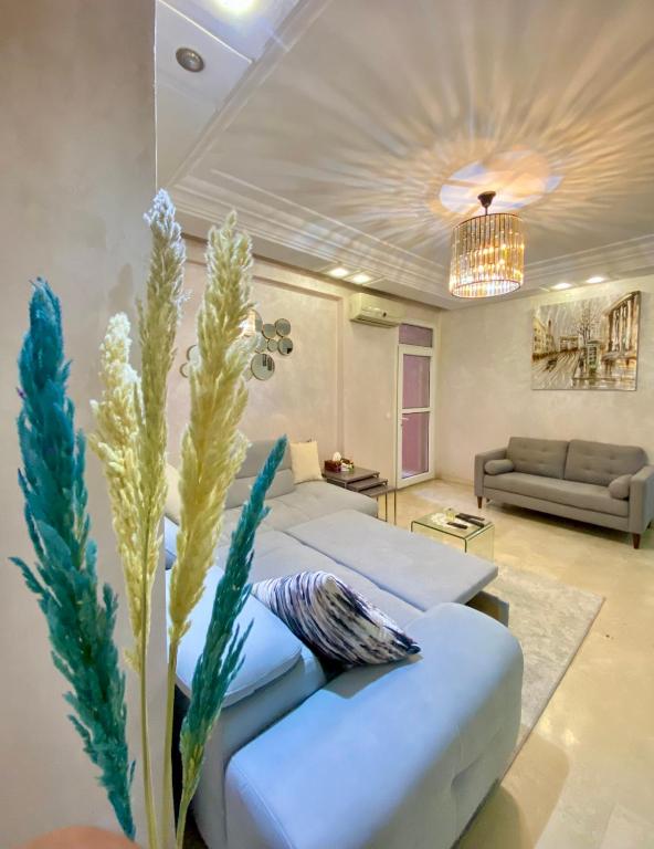 a living room with two white couches and a couch at Appartement de lux in Casablanca