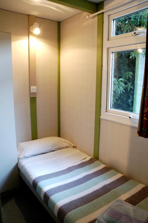 A bed or beds in a room at Camping As Cancelas