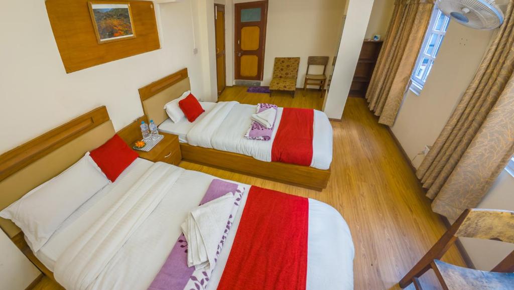 Postel nebo postele na pokoji v ubytování Durbar Guest House