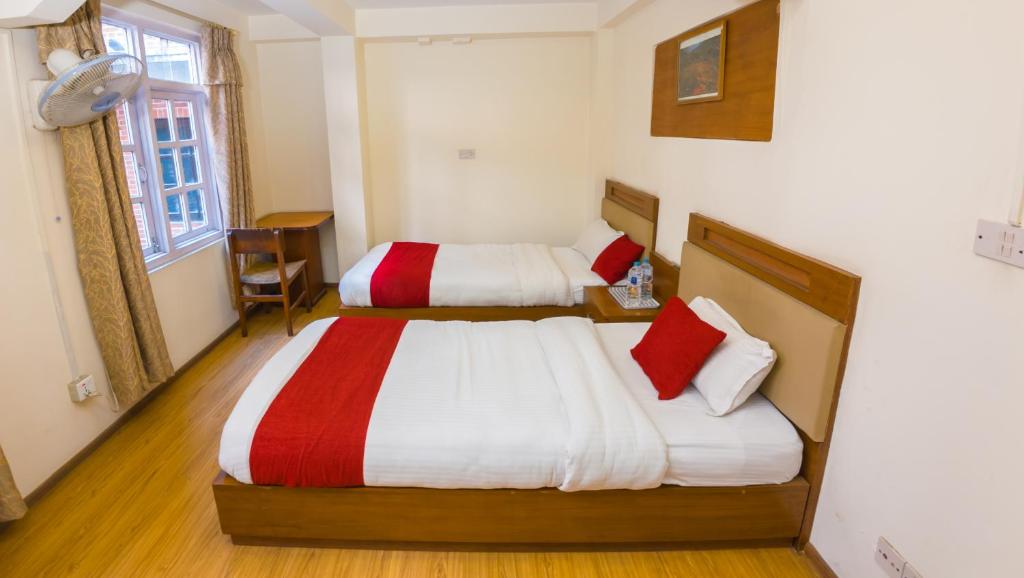 Postel nebo postele na pokoji v ubytování Durbar Guest House