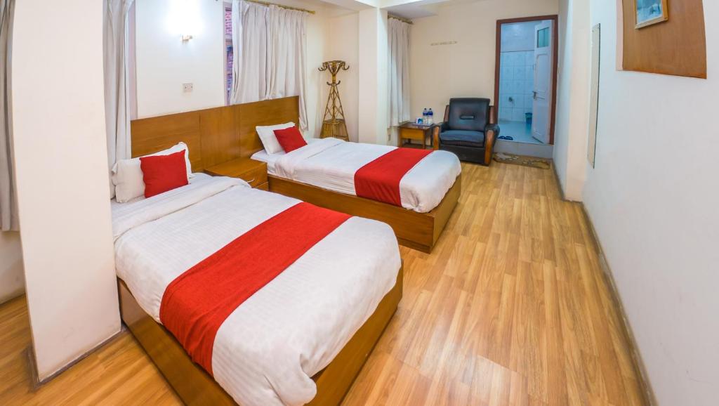 Postel nebo postele na pokoji v ubytování Durbar Guest House