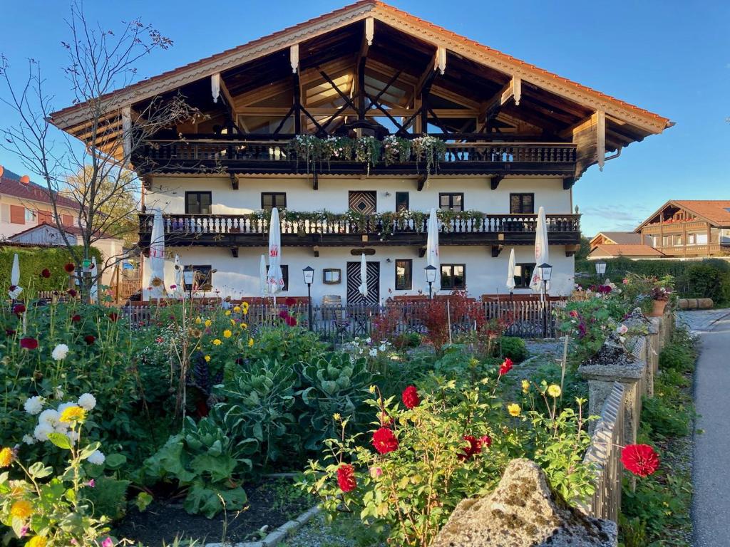 a building with a flower garden in front of it at Ferien beim Müllner in Brannenburg