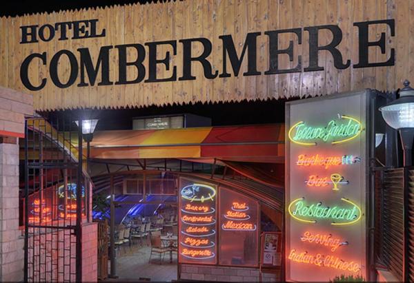 a hotel entrance with neon signs and a hotel compare at Hotel Combermere in Shimla