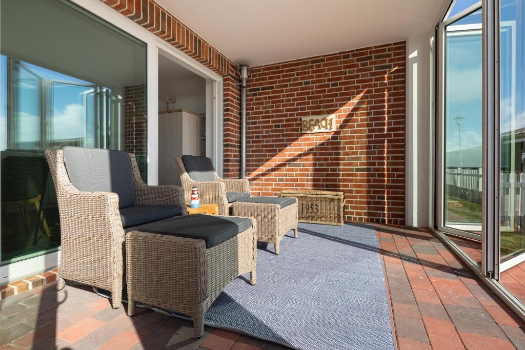 Posezení v ubytování Deichsonne - mit Wintergarten und Blick Richtung Wattenmeer