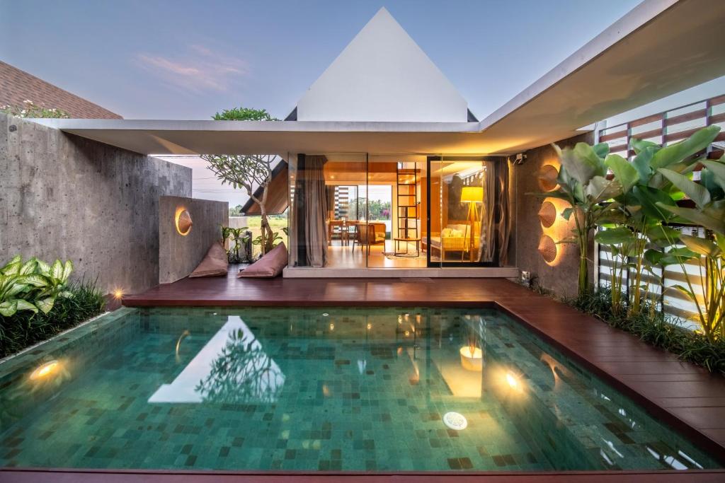 a swimming pool in the backyard of a house at Villa Amiti - Luxurious Haven Loft in Ricefields in Ubud