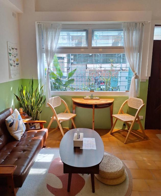 a living room with a couch and a table at Good Stay in Tainan
