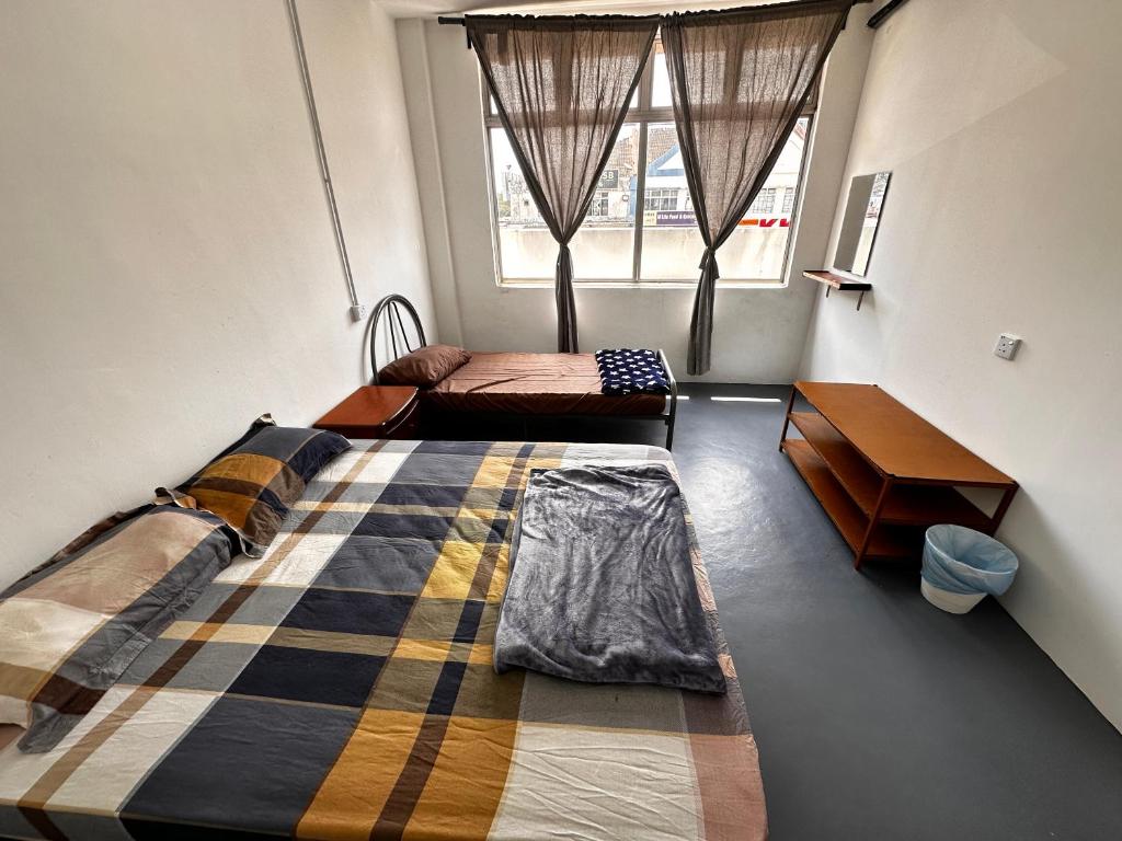 Voodi või voodid majutusasutuse Jiaxin Dormitory - Puteri Wangsa 家馨旅舍 toas