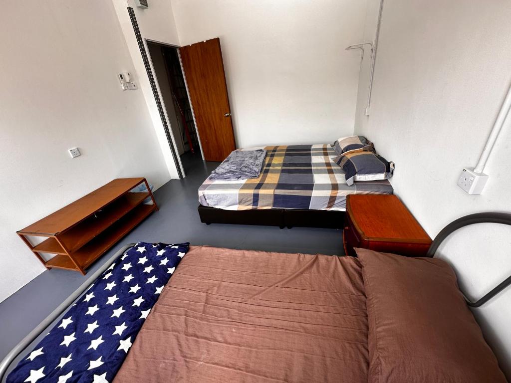 Voodi või voodid majutusasutuse Jiaxin Dormitory - Puteri Wangsa 家馨旅舍 toas