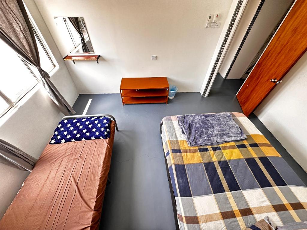 Voodi või voodid majutusasutuse Jiaxin Dormitory - Puteri Wangsa 家馨旅舍 toas