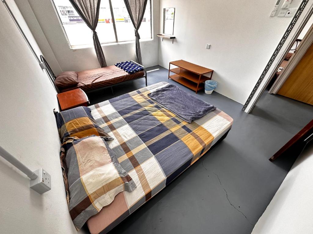 Voodi või voodid majutusasutuse Jiaxin Dormitory - Puteri Wangsa 家馨旅舍 toas