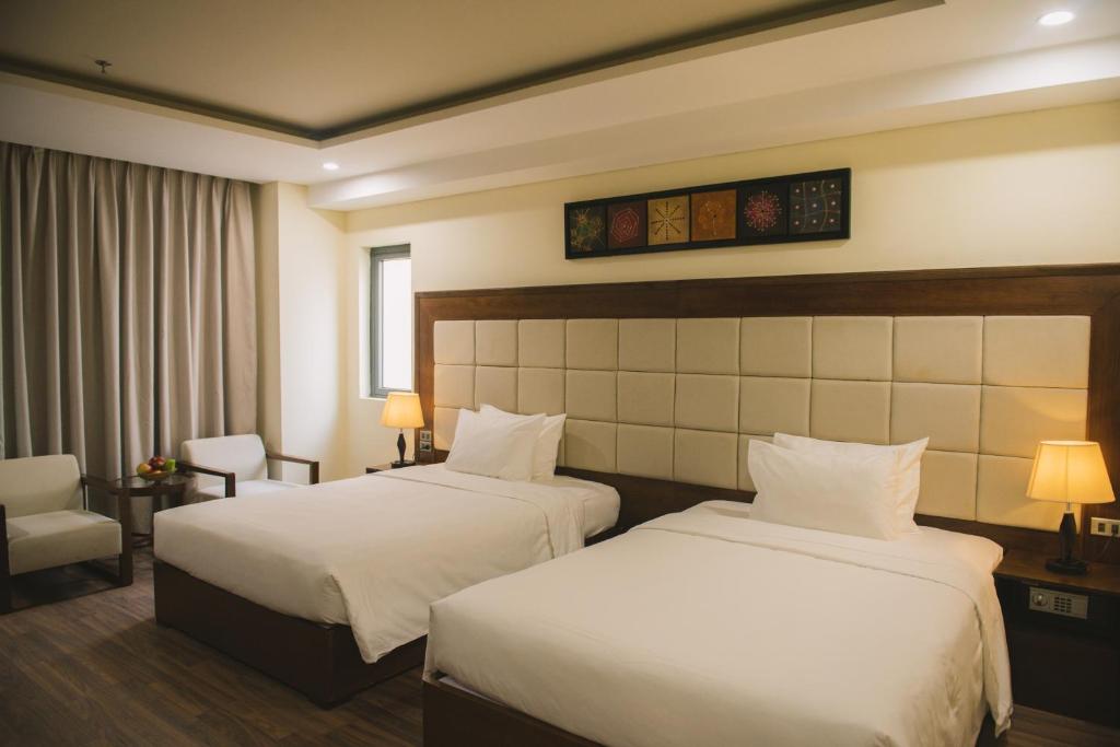 Postel nebo postele na pokoji v ubytování Grand Sea Hotel Danang
