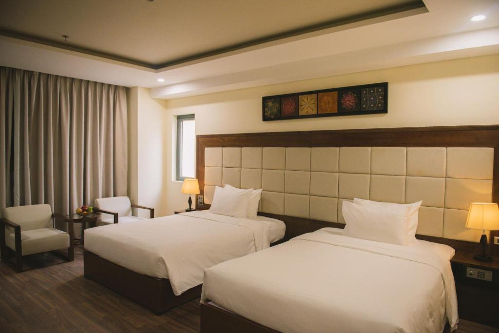 Postel nebo postele na pokoji v ubytování Grand Sea Hotel Danang