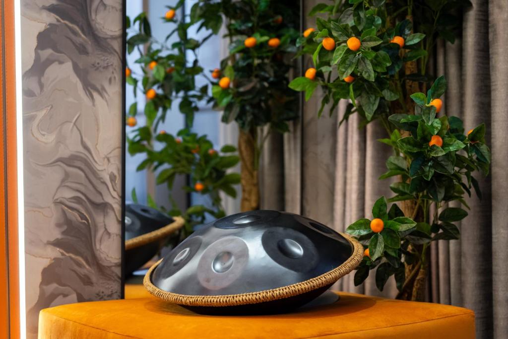 a bowl sitting on top of a table with oranges at 64th floor Skyline Pool with Burj Khalifa View in Paramount Hotel Midtown in Dubai