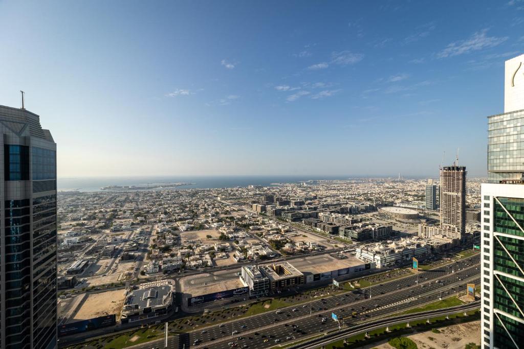 an aerial view of a city from a skyscraper at 64th floor Skyline Pool with Burj Khalifa View in Paramount Hotel Midtown in Dubai