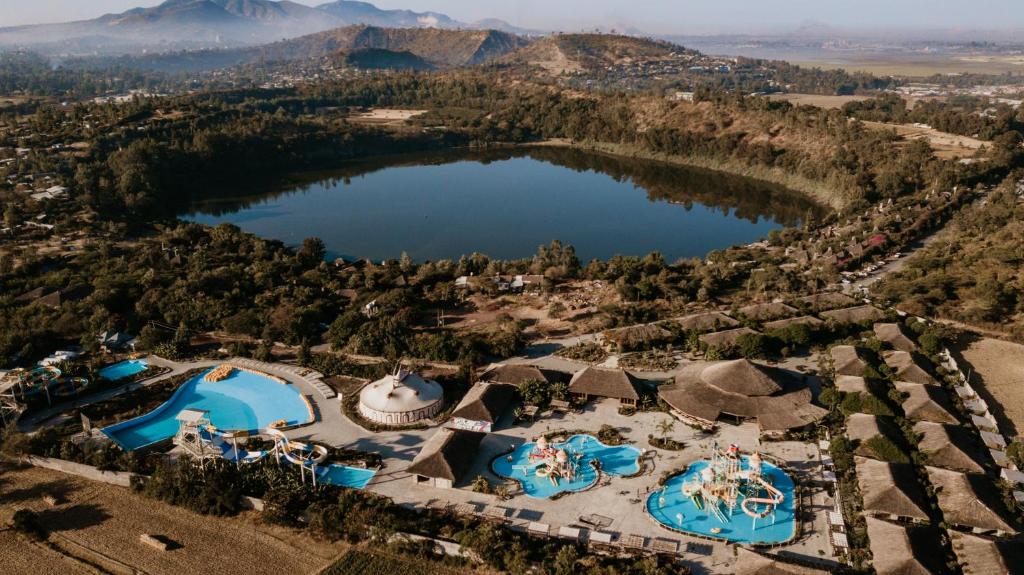 an aerial view of a resort with two pools and a lake at Kuriftu Resort & Spa Bishoftu in Debre Zeyit