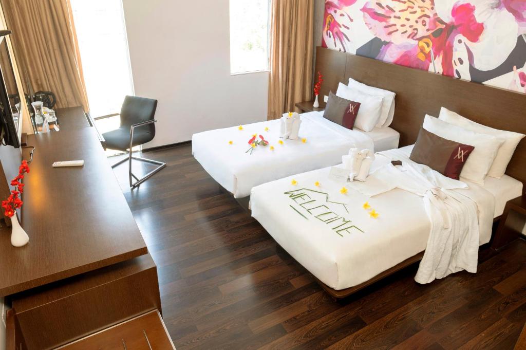 Postel nebo postele na pokoji v ubytování Akmani Hotel Jakarta