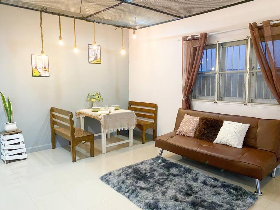 a living room with a couch and a table at Nearly City, full facilities in Chiang Mai