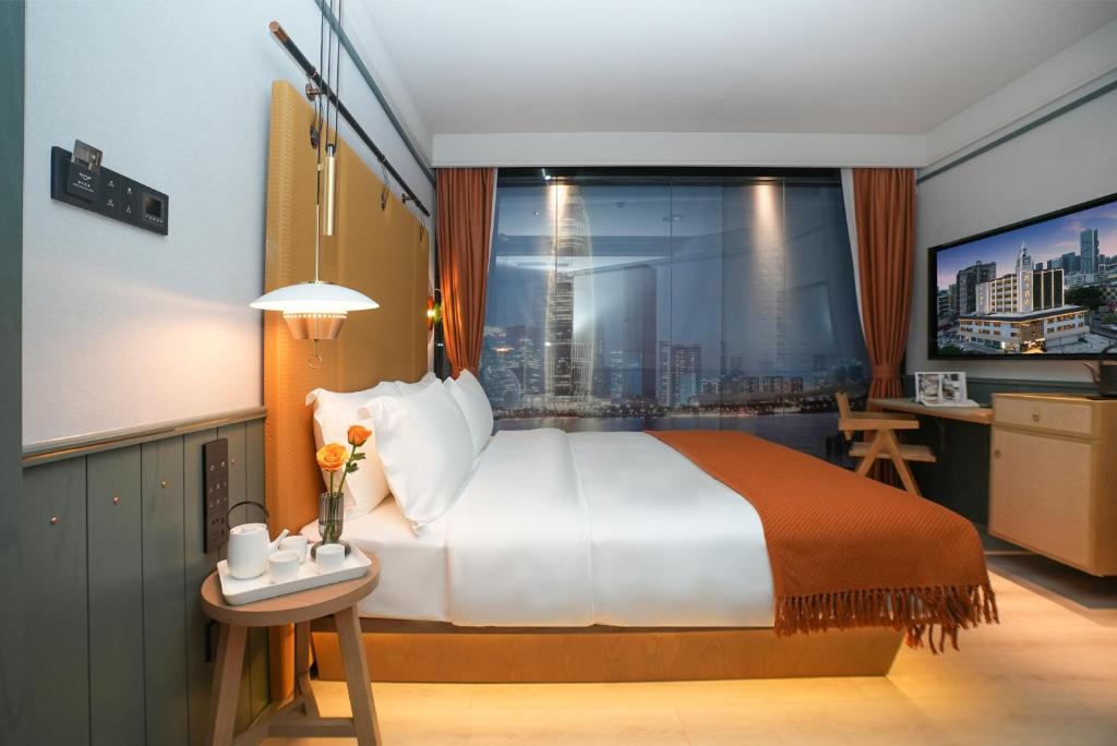 Postel nebo postele na pokoji v ubytování Shenzhen Xili Ruixi Hotel