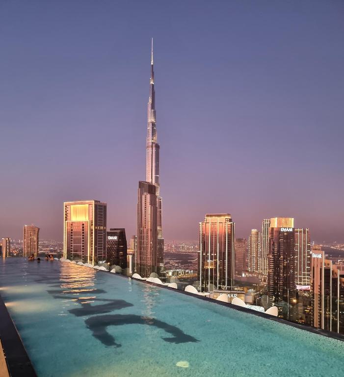 a swimming pool on top of a city skyline at 64th floor Skyline Pool with Burj Khalifa View in Paramount Hotel Midtown in Dubai