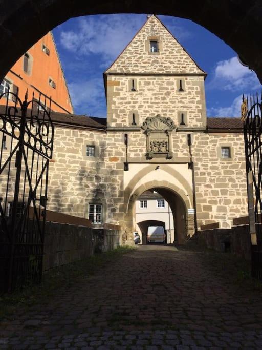 a large stone building with an archway in front of it at Ferienwohnung im Schloss Obersontheim in Obersontheim