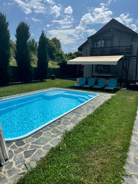 a swimming pool in the yard of a house at Casa Fred in Sîmbotin