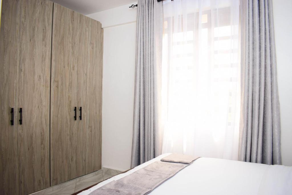 Postel nebo postele na pokoji v ubytování Mzinyi Homes