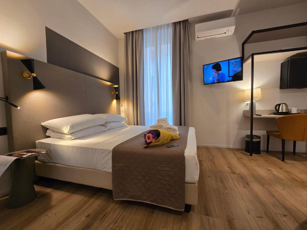 Postel nebo postele na pokoji v ubytování Hotel Porta Pia