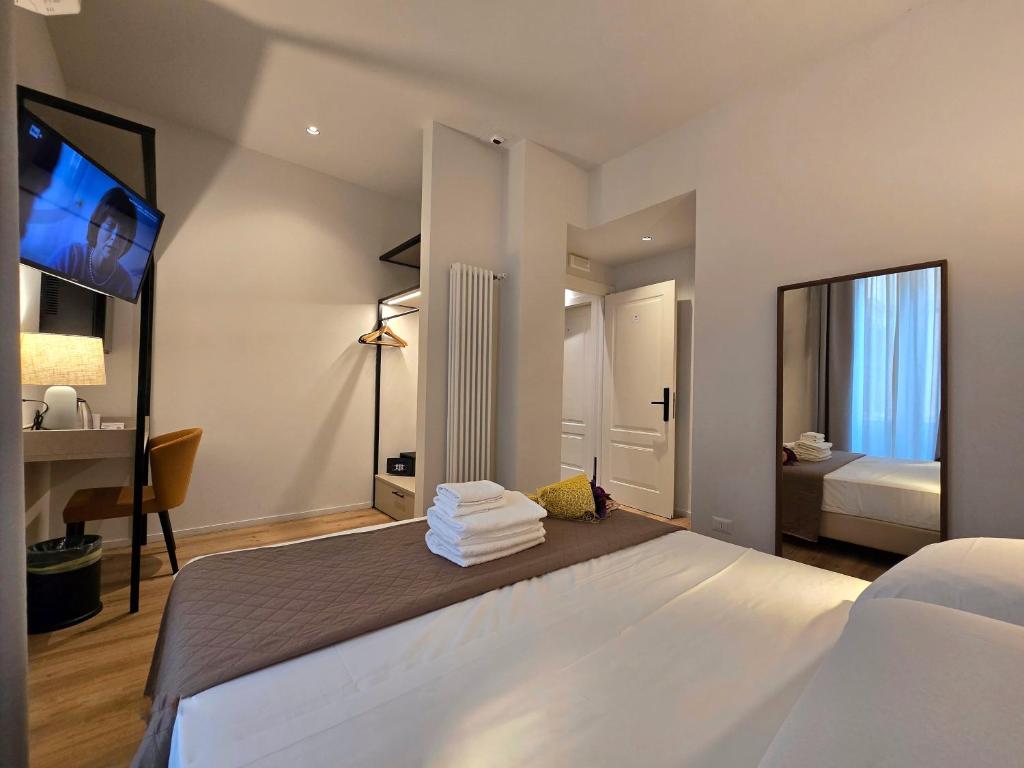 Postel nebo postele na pokoji v ubytování Hotel Porta Pia