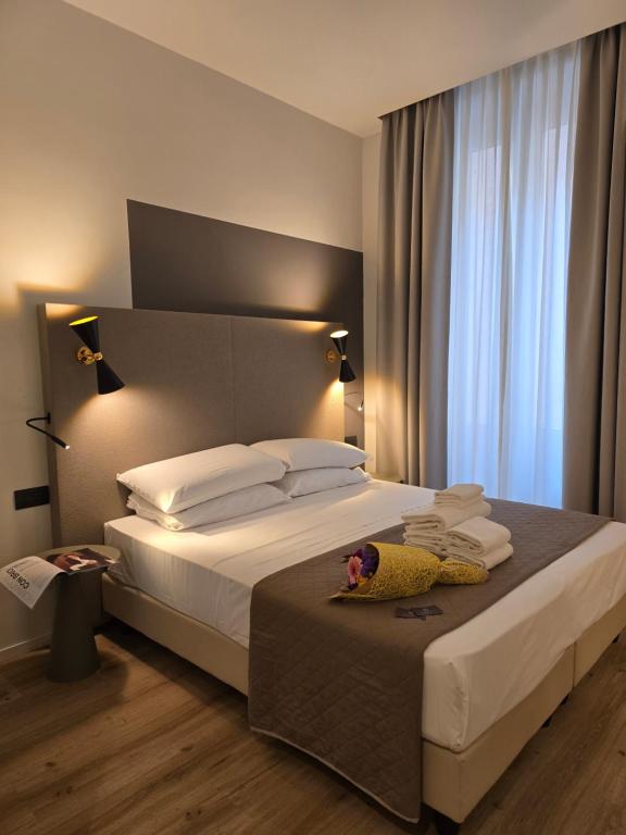 Postel nebo postele na pokoji v ubytování Hotel Porta Pia