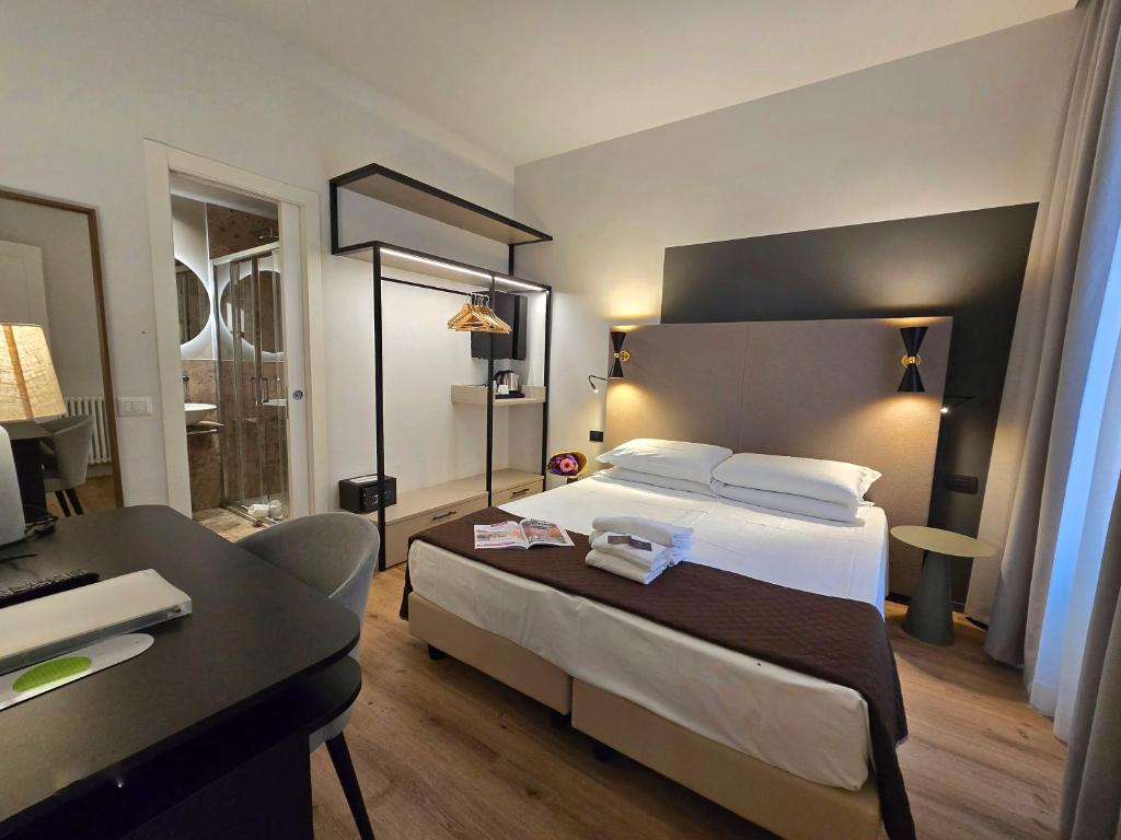 Postel nebo postele na pokoji v ubytování Hotel Porta Pia
