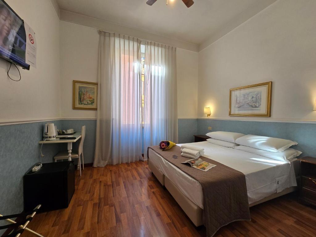 Postel nebo postele na pokoji v ubytování Hotel Porta Pia