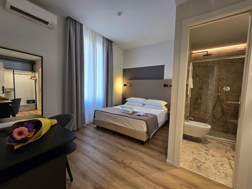 Postel nebo postele na pokoji v ubytování Hotel Porta Pia