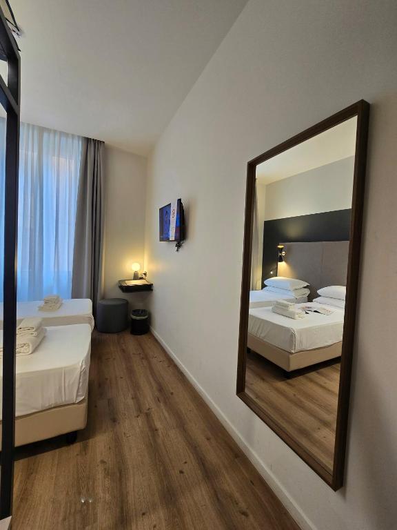 Postel nebo postele na pokoji v ubytování Hotel Porta Pia