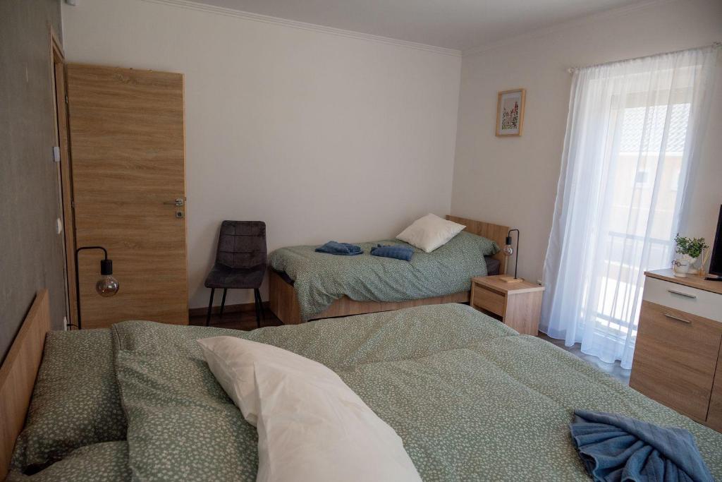 Postel nebo postele na pokoji v ubytování Pipi és Papi vendégház