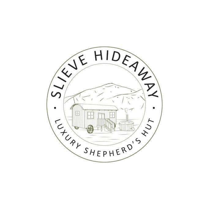 a logo for a hobbit house in the mountains at Countryside Shepherds Hut with hot tub wood fired in Gransha
