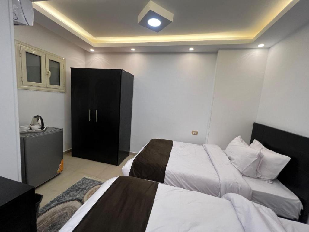 Postel nebo postele na pokoji v ubytování Rixsos Pyramids Inn