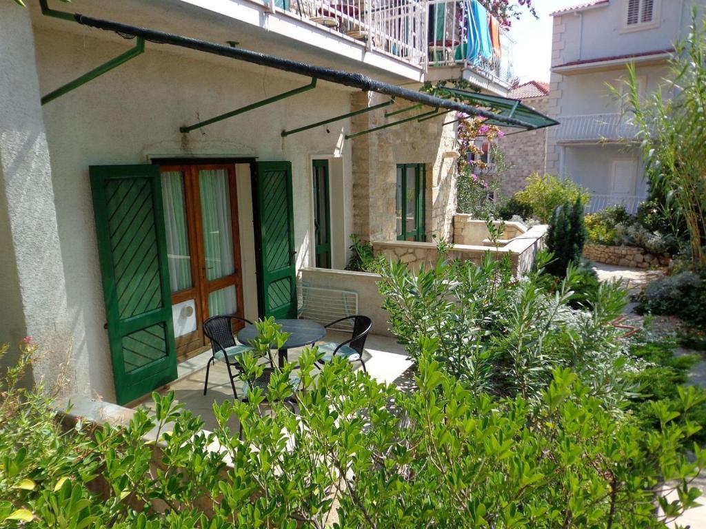 a patio with two chairs and a table in front of a building at Apartment Brane in Bol
